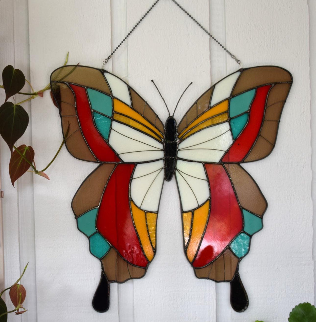 Large handmade stained glass butterfly suncatcher with bold color wings