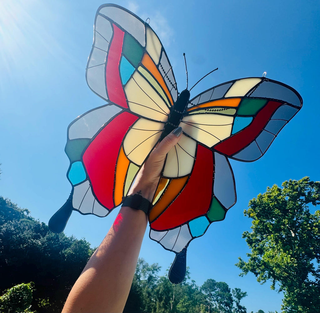 Large handmade stained glass butterfly suncatcher with bold color wings